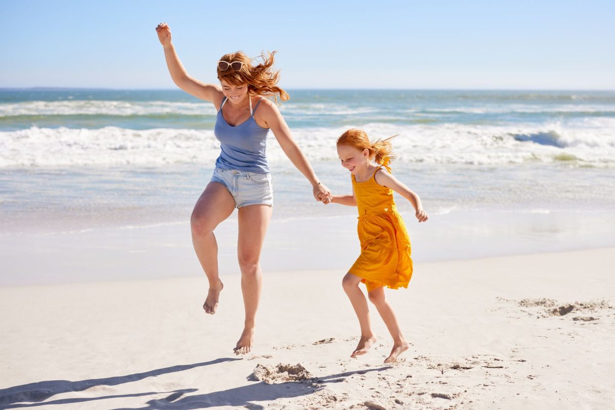 Mother and daughter playing on the beach